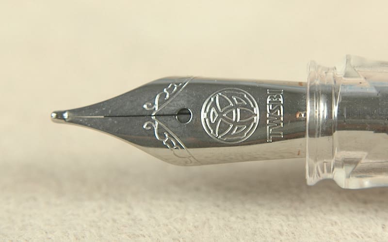 Fountain pen nib with intricate engraving.