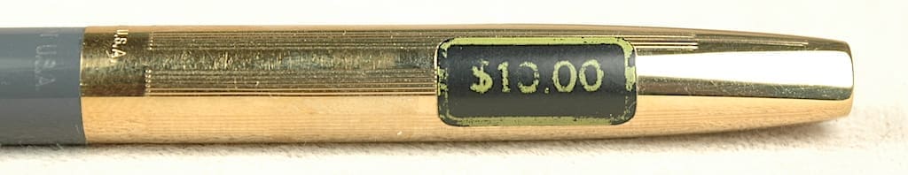 Gold pen with $10.00 price tag.