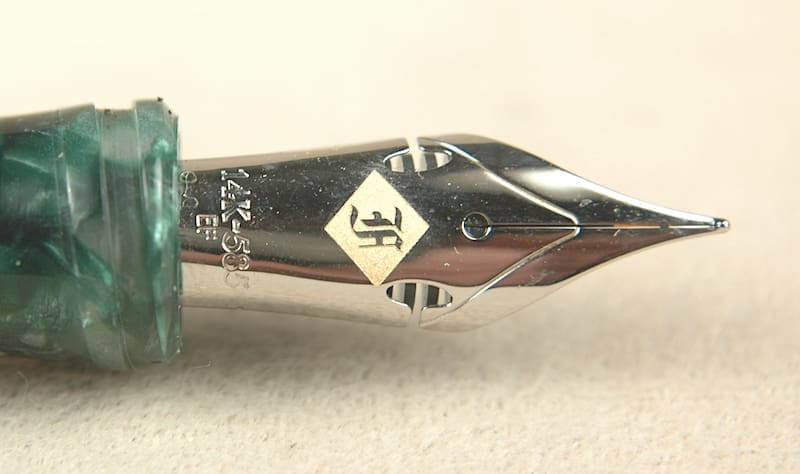 Fountain pen nib with intricate design detail.
