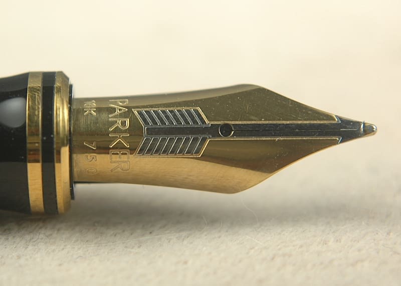 Gold fountain pen nib close-up.