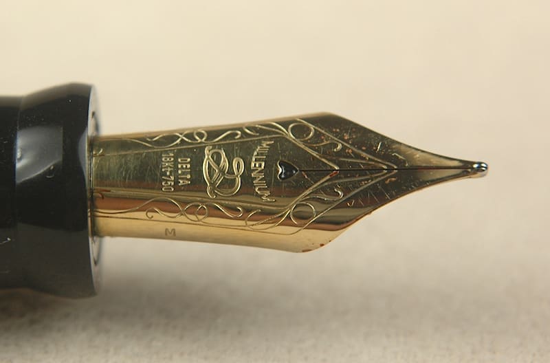 Gold fountain pen nib with engraved details.