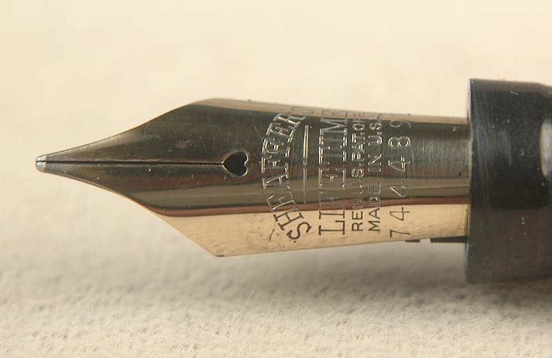 Fountain pen nib with engraved text.
