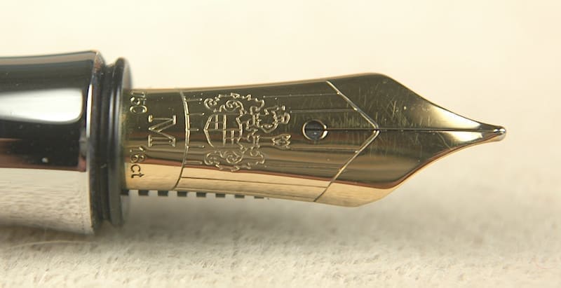 Gold fountain pen nib with intricate engraving.