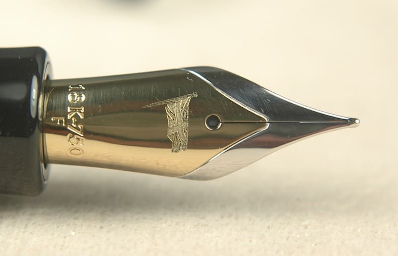 Gold-tipped fountain pen nib close-up.