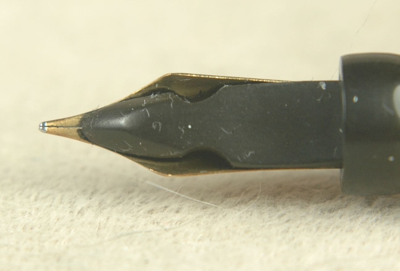 Fountain pen nib close-up on table.