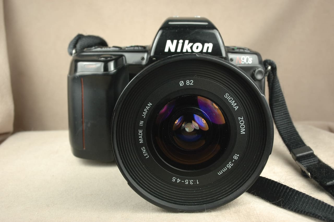 Close-up of a Nikon DSLR camera with a wide-angle lens attached.