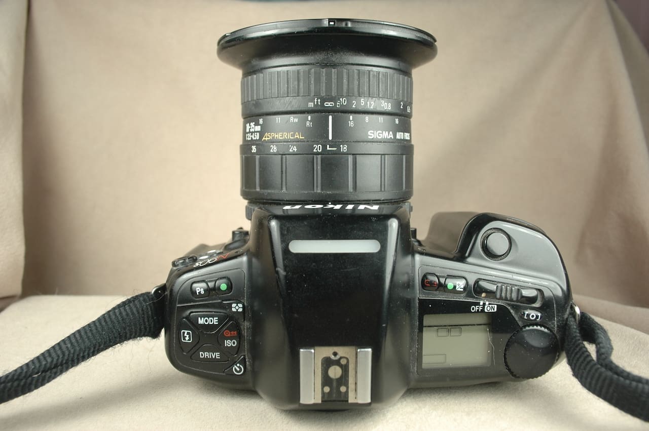 Top view of a vintage SLR camera with wide-angle lens attached.
