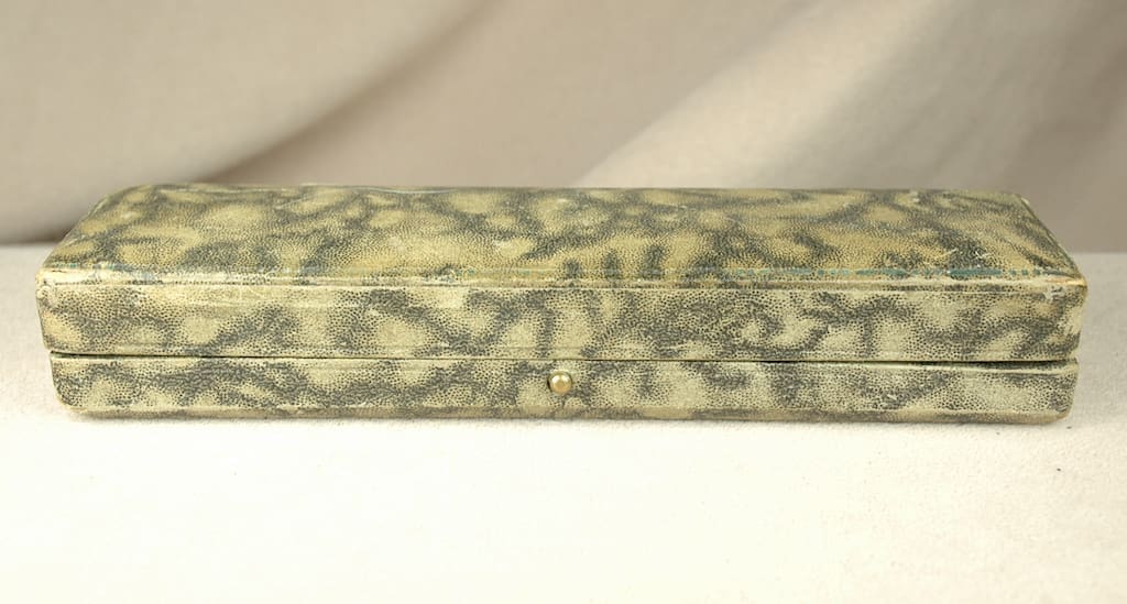 Patterned rectangular jewelry case on white background.
