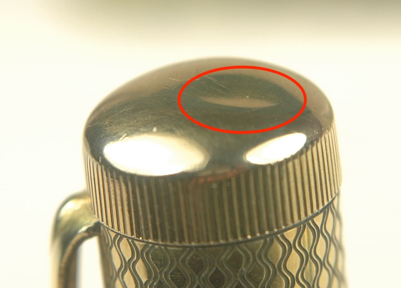 Metallic object with a red-circled area.