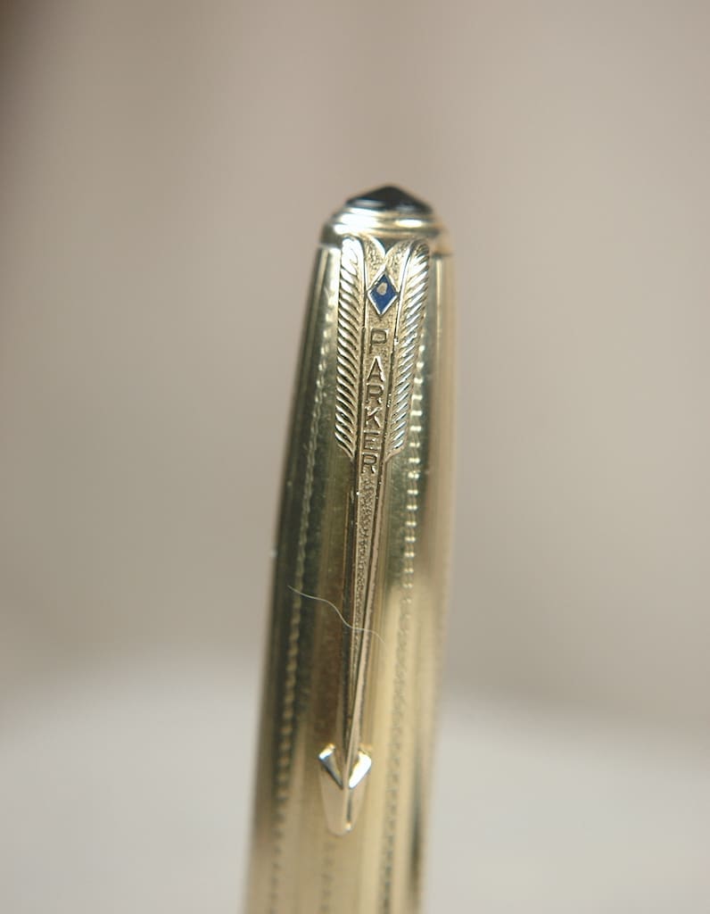 Close-up of a metal pen tip with intricate grooves.