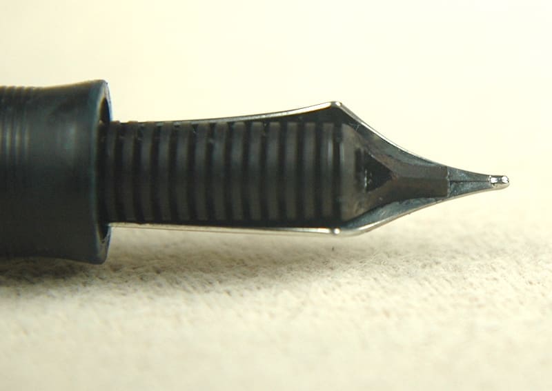 Close-up of a fountain pen nib and grip section.