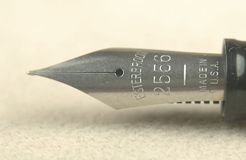 Close-up of a fountain pen nib with engraved numbers and letters.