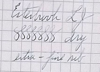 Close-up of handwritten cursive text on grid paper.