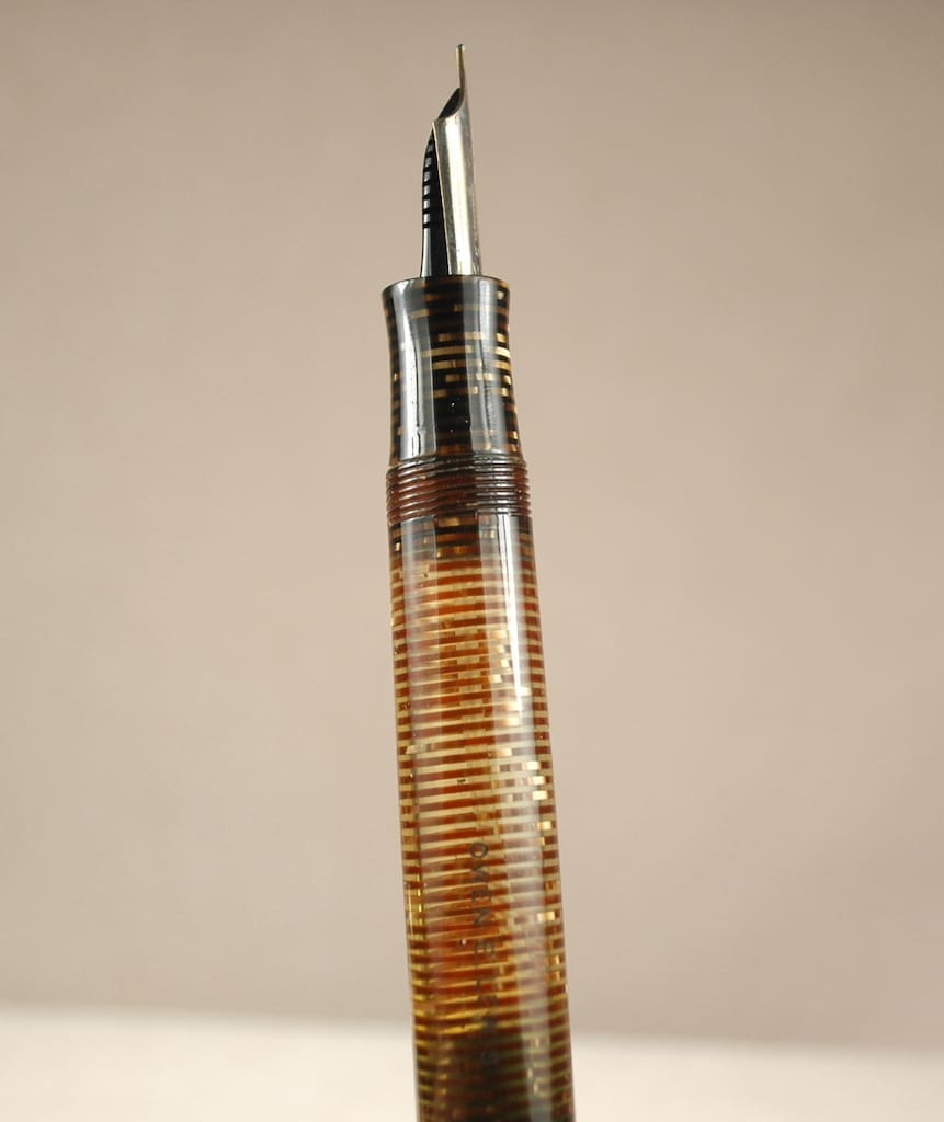Close-up of a vintage syringe filled with a brownish liquid.