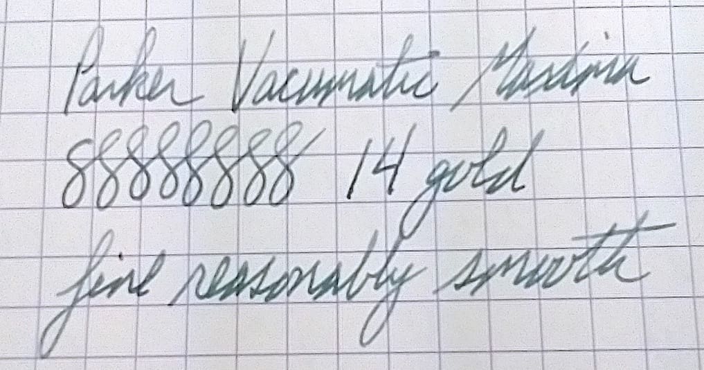 Close-up of handwritten cursive text on graph paper.