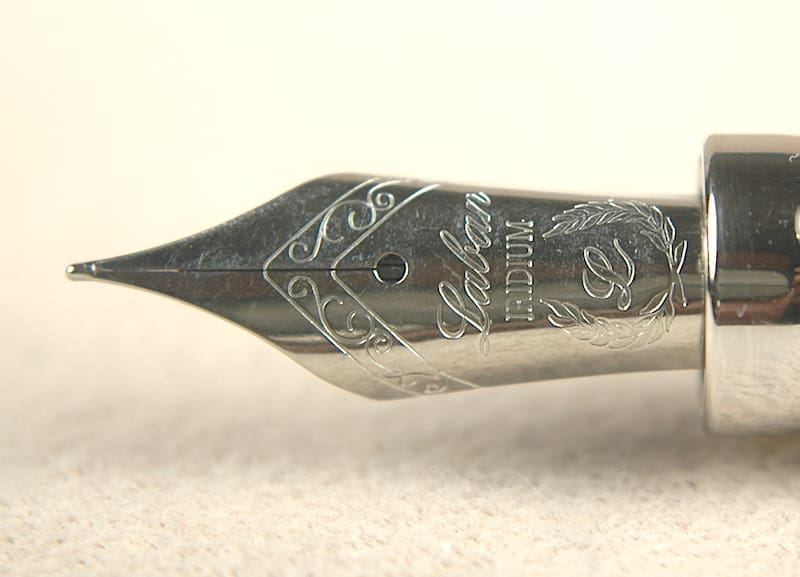 Close-up of a fountain pen nib with intricate engravings.