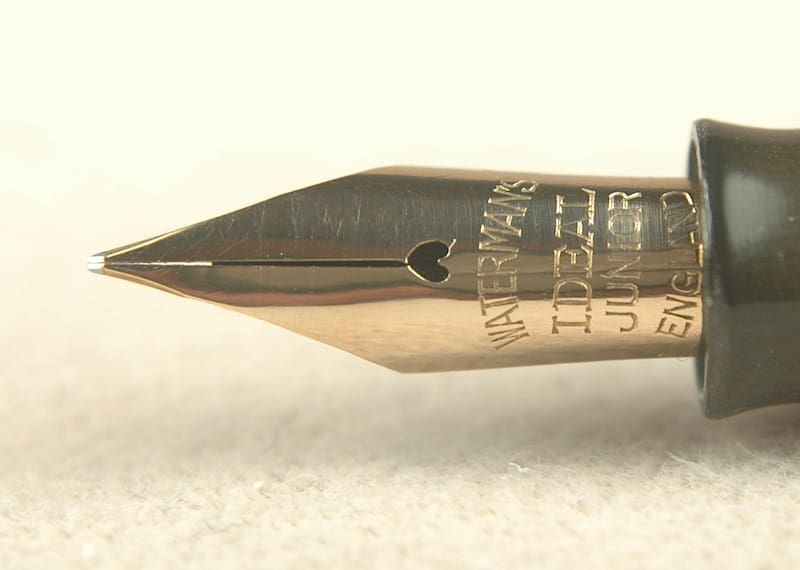Close-up of a vintage fountain pen nib with intricate engravings.
