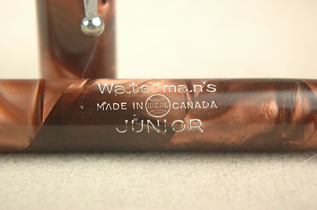 Close-up of a wooden baseball bat with engraved text.
