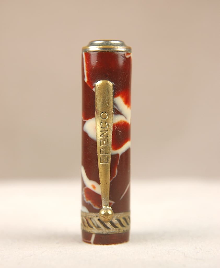 A decorated pen with a floral design and gold accents.