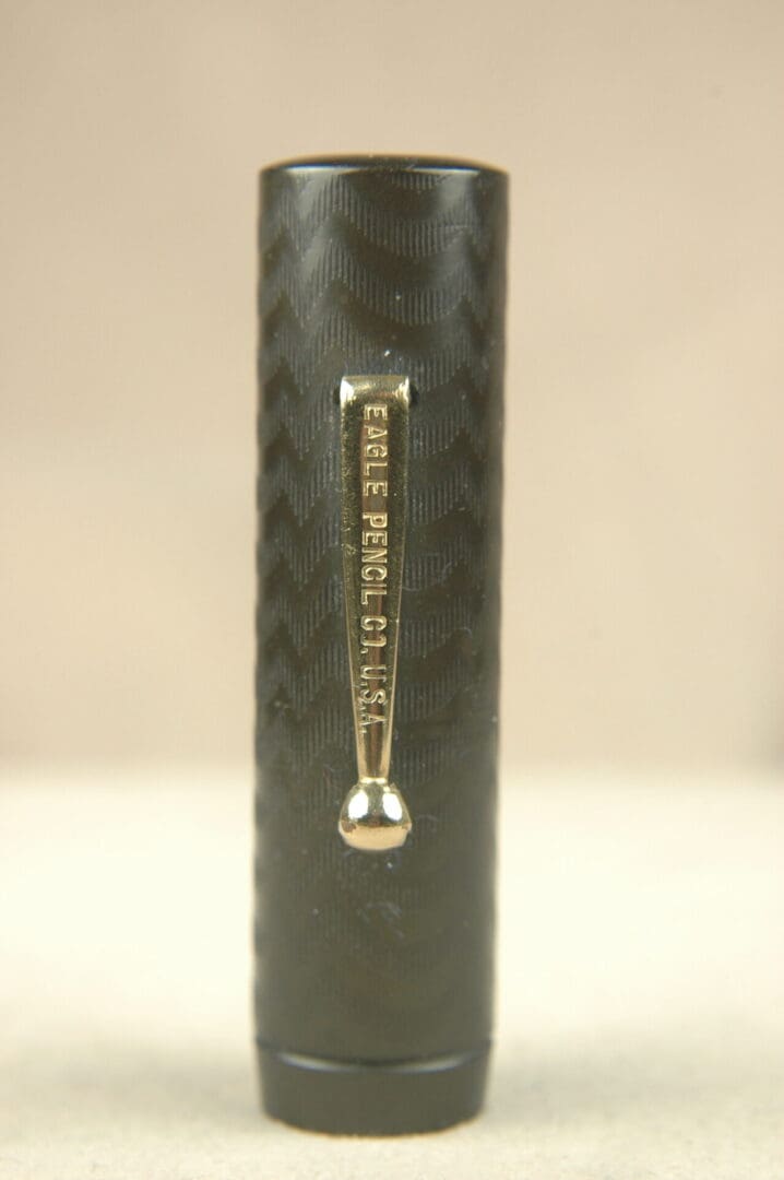 Close-up of a black textured surface with a vertical metal embellishment.