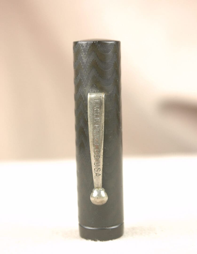 A close-up of a book spine with a silver spoon-shaped ornament.