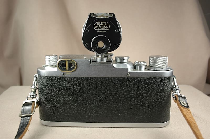 Vintage camera with a textured black body and silver details.