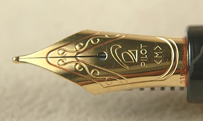 Close-up of a gold Pilot fountain pen nib with intricate engravings.