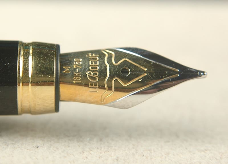 Close-up of a gold and silver fountain pen nib.