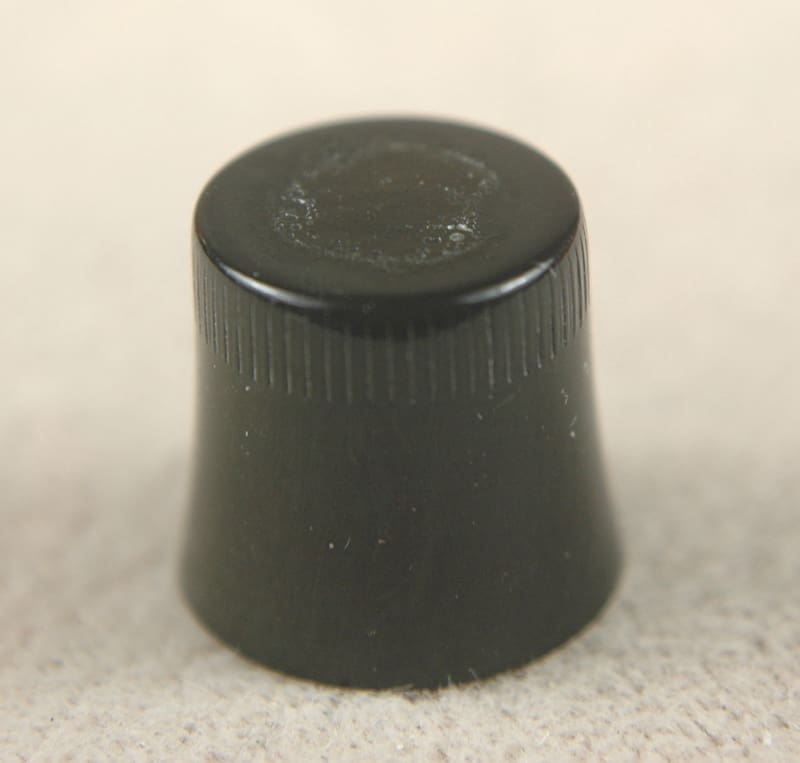 A small black plastic cap or knob with ridged sides.