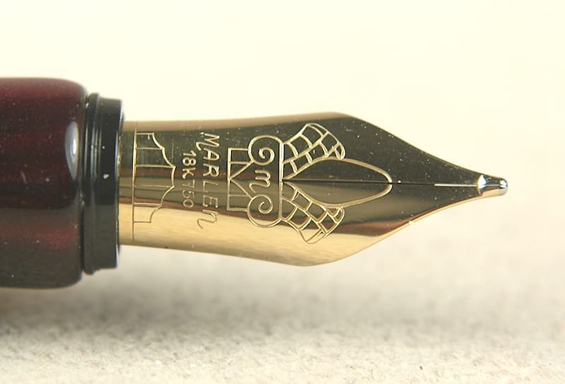 Close-up of an elegant fountain pen nib with intricate designs.