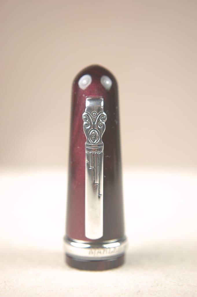 A silver lion emblem on a dark red pen cap.