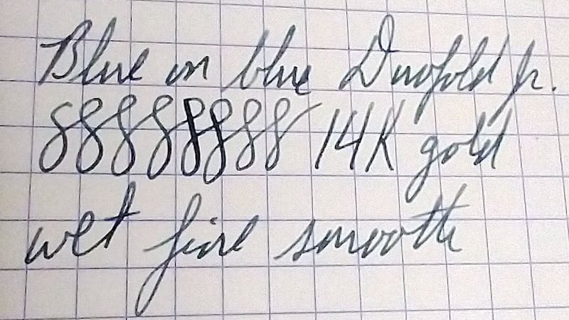 Close-up of handwritten text on graph paper with ink pen strokes.