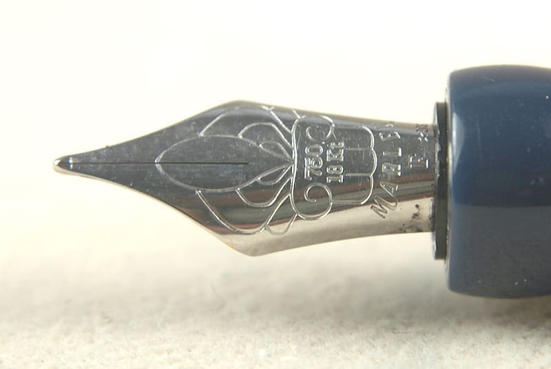 Close-up of a detailed fountain pen nib with intricate engravings.