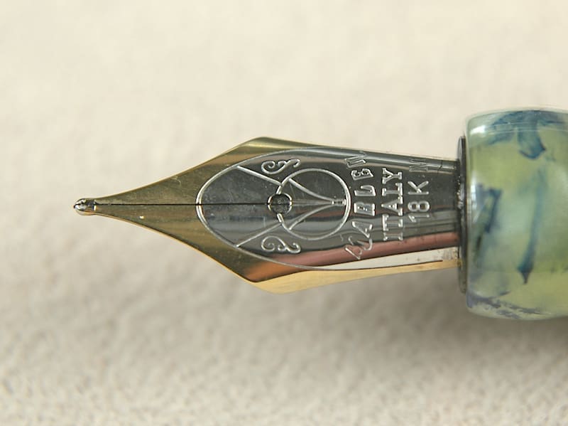 Close-up of an ornate fountain pen nib with intricate engravings.
