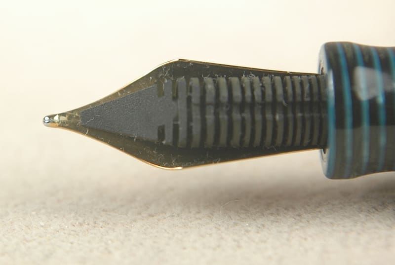 Close-up of a fountain pen nib with engraved details.