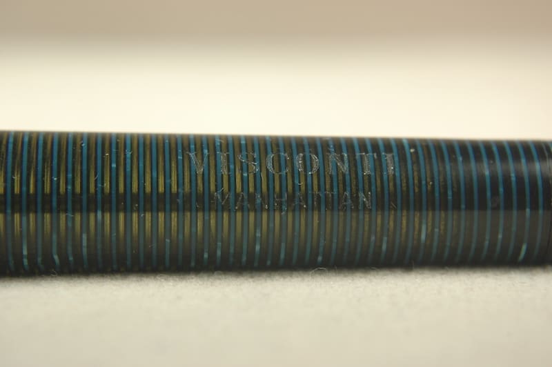 Close-up of a threaded metal rod with fine, evenly spaced threads.